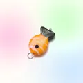 Vibrant orange and white striped fish pendant made of glossy glass with a metal ring - Orange White Striped Fish Charm