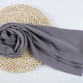 Dark grey chiffon hijab scarf with rose flower styling on woven mat background - 115