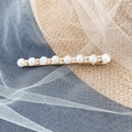 Elegant gold pearl barrette clip with inlaid rhinestones on a soft white mesh background - Eight Pearl Rhinestone Bobby Pin
