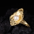 Macro shot of large white freshwater pearl set on textured golden organic petal band - Gold Natural Pearl