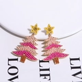 Detail shot of Christmas tree earrings with pink beads and star charms on white background - Rose Pink Christmas Tree With Star Top