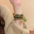 Détail du bracelet bohème multicouche en bois de santal avec breloque arbre de vie et pompon - Style de Perles en Bois Multicouches Bohème