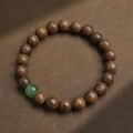 Natural gold silk nanmu wooden beads bracelet with a green jade accent and grain texture - Golden Sandalwood 8mm With Jade