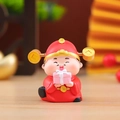 Macro shot of cute resin Caishen figure holding a pink gift box on wooden surface - 1081-10 Extremely Wealthy Caishen