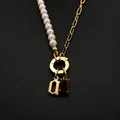 Split pearl and link chain necklace featuring a Gothic initial and red crystal stone - Gothic Letter A / Gold
