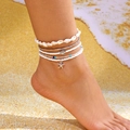 Detail of layered bohemian starfish shell anklets on sand, beach vacation jewelry set - Starfish Turtle 5-Piece Set