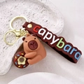 Porte-clés Capybara avec donut, bracelet en silicone marron et garnitures dorées - Donut