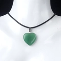Green crystal heart pendant necklace with black cord on white mannequin model - Green Aventurine
