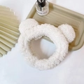 Close-up of a white plush headband with cute bear ears on a tray with decor - Bear Hairband / White