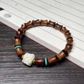 Bamboo-shaped ebony wood bracelet with white floral bead and turquoise accents - 7x8mm Bamboo Joint Awakening Lion