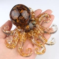Octopus resin ornament featuring tiger eye stones and gold foil flakes in palm size - Tiger's Eye