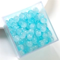 Macro view of blue translucent round glass jelly beads with cat eye effect in a box - Blue Series Apple Bead