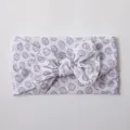Soft nylon baby headband featuring a large white bow with gray volleyball print patterns - White Volleyball Pattern