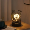 Close-up of black geometric iron wire lamp with rope handle and warm retro bulb - Hexagonal Handheld Lantern / Warm Light-Battery Type