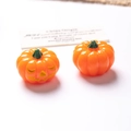 Detailed view of resin Halloween mini pumpkins with glowing Jack-O-Lantern smiling face - Solid Orange Pumpkin Orange Eyes Non-Luminous / 3D
