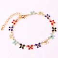 Macro detail of gold-plated alloy bracelet with colorful enamel flower pendants and lobster clasp - Multicolor Bracelet I