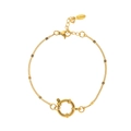Detailed close-up of golden stainless steel chain bracelet with a large sailor clasp - Beaded Chain Style