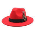 Detailed view of red wool felt fedora featuring black ribbon band and decorative feather - M (56-58cm) / Red