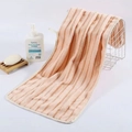 Soft coral fleece towel in salmon pink with a vertical ribbed texture for face washing - Coffee