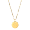Macro view of gold elephant coin necklace featuring delicate white enamel bead accents - Elephant