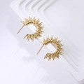 Detailed view of gold sunburst C-shaped earrings on a white minimalist display stand - Gold Sunburst Spiked Hoop