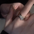 Gold plated open ring with double T design and micro-pave zircons worn on index finger - Gold Double T Intertwined Pavé Style