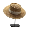 Detail view of natural straw boater hat weave and beige ribbon band on display - Khaki + Beige Ribbon