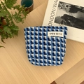 Detailed view of woven blue and white pencil case with a minimalist quote label - Blue Checkered Square Bag