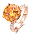 Elegant rose gold ring with large round orange gemstone and pavé-set side stones - Ur0542