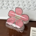 Pink translucent flower hair claw clip with spiral patterns on a wooden surface - 5.3cm / Pink