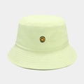 Close-up of classic yellow smiley face embroidery on a premium cotton bucket hat - One Size / Yellow-Green
