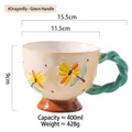 Ceramic mug with hand-painted yellow flowers and green twisted handle design - Dragonfly Flower