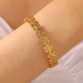Golden stainless steel bracelet with cutout five-petal flower link design worn on wrist - Five-Petal Flower Link (5130) / Gold