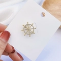 Ship wheel shaped brooch in golden finish with white zircon crystals and nautical design - Ship Helm Style (90246I)