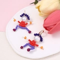 Detailed view of handmade beaded cartoon character earrings with faux pearls and metal hooks - Red Blue Orange Style (Picture 4)