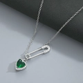 Detailed shot of silver safety pin necklace with heart green zircon and pavé crystals - Silver/Green