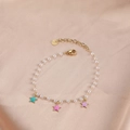 Elegant pearl bracelet featuring colorful enamel stars and a gold-plated lobster clasp - Pearl Three Color Stars