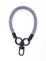 Close-up of blue and white denim braided phone lanyard with black metal rings and hook - Blue Fin