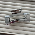 Detailed view of large silver metal hair claw clip with mirror finish on beige fabric - Square Silver 10.5cm