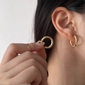 Close-up of elegant gold hoop earrings showing the polished finish and earlobe fit - Polished Simple Gold Hoop