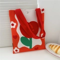 Detail of flower knit tote bag with handmade label and high-quality woven texture - Tulip Orange