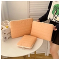 Detailed view of quilted laptop sleeves in orange-pink with various sizes and ring zippers - Small / Pink