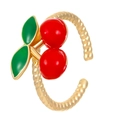 Close-up of golden twist ring with red cherry and green leaf enamel details - Adjustable Open / Gold Cherry Style
