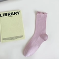 Light purple modal ribbed socks with ruffle cuffs on white background with green book - Deep Pink