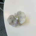 Macro detail of orchid hair clip with iridescent petals and a central pearl accent - Iridescent Grey Purple Orchid