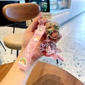 Pink unicorn liquid sand keychain with wish wrist strap and gold bell accessory - Pink-Lollipop Unicorn