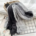 Gradient grey thin wool shawl with soft fringe edges displayed on woven basket - Black Grey Gradient