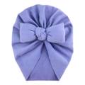 Close-up of a soft purple baby turban hat featuring a large decorative plush bow - Purple