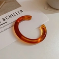 Translucent amber acrylic C-shaped open cuff bracelet with dark marble texture - Amber