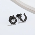 Macro view of minimalist black U-shaped horseshoe stud earrings in stainless steel - Matte Black